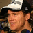 A pixelated close-up of a person wearing a black and white cap, with visible facial features including eyes, nose, mouth, and ear.
