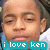 Pixelated close-up of a person's face with closed eyes, wearing light blue and white clothing, overlaid by teal text reading 'i love ken' in lowercase.