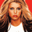 Pixelated static image of a person with long wavy hair wearing a white top and dark jacket against a solid red background.