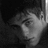 Black-and-white pixelated image of a person's face in profile view with dark hair and closed eyes against a dark background.