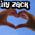 Pixelated image showing two hands forming a heart shape against a blue background with 'iLY ZACH' text in white block letters on black bars.