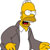 Pixelated yellow-skinned character with large white eyes, open mouth showing red tongue, wearing dark gray suit jacket over white shirt, arms bent at elbows with yellow hands visible.