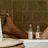 A 4-frame contact sheet showing a man in a bathtub with legs raised and bottles on the edge, transitioning to him sitting up and covering his face.
