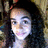 A person with long dark curly hair and a red headband appears in three showing slight facial expression changes