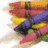 A pixelated image showing a bundle of colorful crayons on the left and purple text reading "Color me Crazy!" on the right, with visible dithering and low-resolution artifacts.