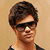 A person with short brown hair and dark sunglasses appears in four with slight variations in head position and background
