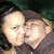 Two people in a close embrace with one person kissing the other's cheek, visible across four