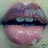 Two identical close-up images of lips with purple upper lip, pink lower lip, and dark blue teeth against a light green background.