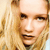 Pixelated close-up of a person with light brown hair and fair skin, showing eyes, nose, mouth, and part of the forehead against a light background.