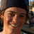Pixelated photo of a person wearing a dark cap with red text reading 'RYAN SHECKLER!!' and 'will you marry me PLZZZ!' on black background.