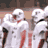 Static image of football players in white uniforms and a man with a cap, overlaid with text reading "Billy Bob Thornton in FRIDAY NIGHT LIGHTS" on black background.
