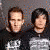 Animated contact sheet of four individuals in black shirts with white text/logos, displayed across three sampled frames showing slight pose variations.