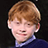 Pixelated image of a person with light brown hair wearing a dark blue sweater over a purple collared shirt, next to text reading 'Not just anotherWeasley.'