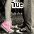 A pixelated image of a person's lower legs and feet in dark pants, with pink shoes visible against a grayscale background.
