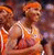 Pixelated image of a person in athletic attire holding an orange basketball, with blurred background colors.