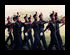 Two side-by-side frames show a group of people in dark graduation gowns raising arms on the left, and the same group in white graduation gowns standing in a line on the right.