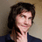 A pixelated image of a person with dark curly hair wearing a dark blue shirt, next to the text "Marry me." on a white background.