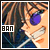 Pixelated image of a person with long brown hair wearing dark blue clothing and purple sunglasses, with a white rectangular box containing the text "BAN" on the left side.