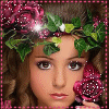 A woman with brown curly hair wears a pink rose and green ivy crown, holding a pink rose-shaped object near her face.