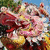 A traditional Chinese dragon dance head with red, yellow, and white colors in a of six showing sequential animation frames