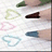 Pixelated static image showing six distinct shapes: a green leaf, a brown shoe, a pink triangle, a blue oval, a light blue heart, and a dark blue rectangle on a white background.