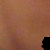 Animated sequence showing a dollar sign icon appearing in the bottom-left corner of a brown textured background with black shapes.