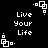 Black background with white pixelated text "Live Your Life" and small square-based geometric patterns scattered across the image.