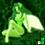Animated green fairy with white wings sits on grassy background, legs bent, arms crossed, head turned right, with small green and white squares in bottom-right corner.