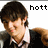 Pixelated image of a person with brown hair wearing a dark jacket over a white shirt, with the word 'hott' in black pixelated text to the right.