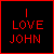 Red pixelated text on black background with red border reads "I LOVE JOHN" in three lines.