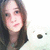 A person with long brown hair and light skin holds a white plush bear against a bright background, visible in multiple views.