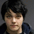 A four- shows a person with dark hair and a dark blue hoodie against a gray background, with white text appearing sequentially