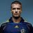 Pixelated image of a man in a dark blue sports jersey with yellow accents, set against a solid blue background with yellow text and symbols.