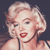 Pixelated close-up of a person with styled blonde hair, red lips, and a light-colored garment against a dark background.
