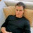 A person in a black long-sleeve shirt sits against a light brown background with green text reading "Matt Damon Is hott" overlaid.