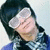 Pixelated static image of a person with dark hair wearing a light-colored headband and blue clothing against a pale background.
