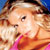 Pixelated static image of a person with light brown hair wearing a pink top against a blue background, likely a celebrity or character icon from early internet culture.