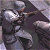 Pixelated character in dark armor with silver helmet and shoulder pads, standing against a gray background.