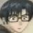 Pixelated close-up of a character with dark hair and glasses, light skin, and a neutral expression against a gradient background.