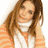 A woman with long brown hair wears an orange and white striped sweater and white scarf, shown in three sequential poses with hand near face.
