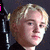 A four- shows a person with blonde hair and dark clothing against a dark background, with pink text overlays changing