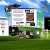 Pixelated static image of a computer monitor on grass with blue sky background, showing two side-by-side panels including text and an indistinct figure.