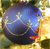 A pixelated circular icon with a blue and purple gradient center, surrounded by yellow and green hues, featuring a small red detail on the right side.