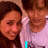 Two people in a close-up pose with text overlays changing across frames, showing 'I', 'LOVE', and 'HUNTER' in cyan pixelated font.