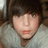 A pixelated image of a person with brown hair and a light-colored sweater, next to purple text reading 'I Love Tyler <33' on a black background.