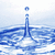 Animated water droplet forming a splash with ripples on blue background, transitioning to green and light blue with white dots and heart shapes