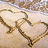 Pixelated static image of a heart-shaped outline formed by brown and tan curved lines on a light beige background with a blurred upper section.