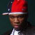 A pixelated figure wearing a red and white cap with a dark brim, a white shirt, and a dark jacket against a dark background.