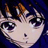 Pixelated anime-style face with large dark eyes, light skin, and brown hair against a dark blue background.