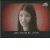 Animated sequence of a person with long dark hair against a red gradient background, showing facial expressions and head movements.